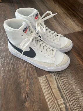 Nike White High-Top Sneakers with Black Swoosh and Red Logo
